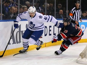 New York Rangers right winger Martin St. Louis (26) defends Maple Leafs left winger Nikolai Kulemin at Madison Square Garden. (USA TODAY Sports)