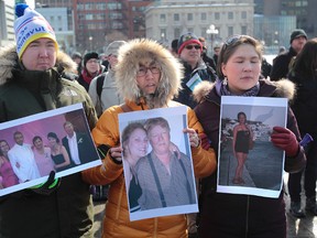 Mourners for Loretta Saunders gathered on Parliament Hill Wednesday March 5, 2014. The Wednesday vigil was organized by the Nova Scotia Native Women's Association who want action on violence against aboriginal women. Hans Kristian Petrussen, Ivana Josefsen and Paninguak Kruse during Wednesday's rally.   
Tony Caldwell/Ottawa Sun/QMI Agency