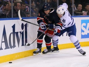 New York Rangers right winger Derek Dorsett (15) and Toronto Maple Leafs defenceman Morgan Rielly (44) battle for the puck during the second period at Madison Square Garden on March 5. (Adam Hunger, USA Today Sports)