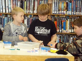 As part of Engineering Week activities, the Wallaceburg library hosted an event called Engineering Madness on March 1, with a member of the Engineering Society of Chatham-Kent on hand to provide guidance. From left to right, Josh Hazzard, Joey Taylor, Cameron Hazzard and Walter Wilson work intently to build a house out of different materials.