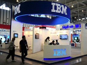Visitors walk past the IBM booth at the 9th China International Software Product & Information Service Expo in Nanjing, Jiangsu province Sept. 6, 2013. REUTERS/China Daily