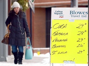 A sign outside Blowes Travel Ltd. on Wellington St. this winter offered a little extra incentive to escape the numbing cold and snow in the city. (SCOTT WISHART/The Beacon Herald files)