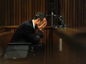 Oscar Pistorius reacts during the fourth day of his trial for the murder of his girlfriend Reeva Steenkamp at the North Gauteng High Court in Pretoria, March 6, 2014. (REUTERS/Werner Beukes/Pool)