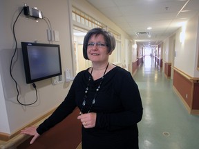 Jeff Tribe/Tillsonburg News
Standing roughly at ‘ground zero’ of significant water damage suffered during the early morning hours of Saturday, January 11, 2014, Woodingford Lodge Oxford County Director Corrie Fransen is framed by a newly-renovated Cedar Crest Wing corridor. A second, more-quickly-contained incident Friday, February 28 in the Rosewood Wing has required additional repairs. The original ‘mid-March’ target for a residential return is still the goal, although with the caveat of required assurance of safety and functionality.