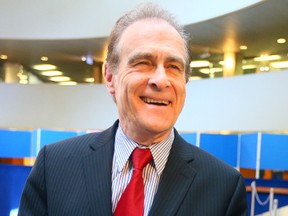 Deputy Mayor Norm Kelly holds a piece of  cake during an event held  to mark Toronto's 180th birthday. (DAVE ABEL, Toronto Sun)