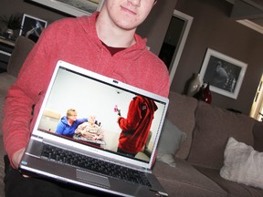 Dan Stewart, 17, of Sarnia, Ont., shows a still image from his Good Deed Nek Nomination video Thursday, March 6, 2014. Instead of crafting an alcohol-fuelled stunt like other Nek Nomination videos, the St. Patrick's student paid for orders at Tim Hortons, visited a nursing home and donated pet toys to the local humane society on tape. (BARBARA SIMPSON, The Observer)