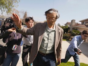 Satoshi Nakamoto is surrounded by reporters as he leaves his home in Temple City, California, March 6, 2014. (REUTERS/David McNew)