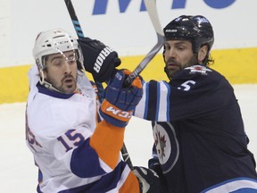Known for his bang-and-crash style of play while with the Wild, Cal Clutterbuck says he's more selective in his hits since joining the Islanders. (Brian Donogh, QMI Agency)
