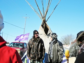 Evelyn Wolff of the Occupy Our Hearts Belleville group speaks with Mohawk activist Shawn Brant  on Shannonville Road in Tyendinaga Township Thursday. Women from the group visited the protest to show their support.  
Janet Richards/The Intelligencer