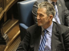 Opposition Leader Brian Pallister looks at a backbencher as the NDP delivered the provincial budget speech at the Manitoba Legislative Building in Winnipeg, Man., on Thu., March 6, 2014. Kevin King/Winnipeg Sun/QMI Agency