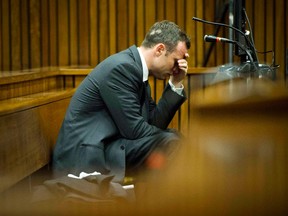 Olympic and Paralympic track star Oscar Pistorius reacts during the fifth day of his trial for the murder of his girlfriend Reeva Steenkamp at the North Gauteng High Court in Pretoria, March 7, 2014. (REUTERS)