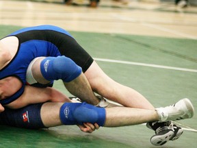 Alex Smith of the Spruce Grove Composite High, who joins the Memorial team for competitions, looks to put the finishing touches on an opponent. - Gord Montgomery, Reporter/Examiner