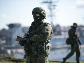 Russian Soldiers stand guard near Ukrainian navy command ship Slavutych at the Crimean port of Sevastopol March 5, 2014.  REUTERS/Baz Ratner