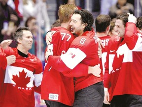 London?s gold medallists Jeff Carter, left, and Drew Doughty celebrate after the men?s hockey final in Sochi. (AFP photo)