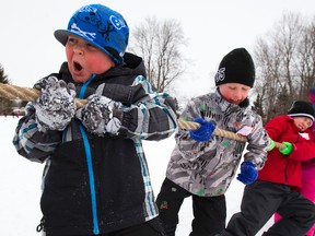 Connor Champ, 6, left, plays the role of leader on his tug of war squad as he shouts out instructions. Students at John P. Robarts celebrated the winter that never ends with their first annual winter carnival in London, Ont. on Tuesday March 4, 2014. Rather than suffering like the rest of Southwestern Ontario, students and teachers got to play games like keeping ball on a parachute, also team skiing, and tug of war. (MIKE HENSEN, The London Free Press)