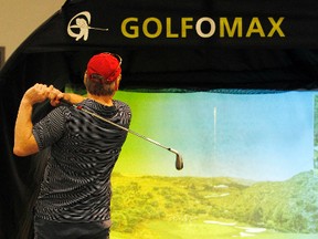 Will Anderson takes his turn at a virtual closest-to-the-pin contest during the 2013 Ottawa Gatineau Golf Expo at the Ernst and Young Centre in Ottawa Saturday, Mar. 09, 2013 .  Darren Brown/Ottawa Sun/QMI Agency