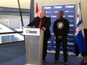 Mayor Rob Ford presents a proclamation to Steven Adu of the Ottawa Redblacks on March 7, 2014. Adu was coached in high school by Ford. (Don Peat/Toronto Sun)