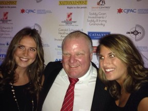 Rob Ford poses with two admirers at CJPAC 2014 on March 6, 2014. (Sue Ann Levy/Toronto Sun)