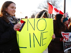 Protesters voice their concerns regarding the approval of Enbridge Line 9 pipeline during a rally that attracted about 75 people on Friday, March 7, 2014 at Confederation Square opposite City Hall on George St. in Peterborough. (CLIFFORD SKARSTEDT/QMI Agency)