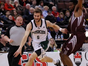 University of Saskatchewan Huskies' Ben Baker, left, is fouled by University of Ottawa GeeGees' Terry Thomas, right, during the first half of the CIS basketball final 8 tournament at the Canadian Tire Centre in Ottawa, Ont. on Friday March 7, 2014. Darren Brown/Ottawa Sun/QMI Agency