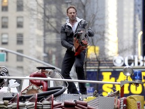 Ian Ziering filming a scene with a chainsaw on top of a fire truck on the set of "Sharknado 2: The Next One" in Manhattan, on Feb. 24 2014. (Dennis Van Tine/Future Image/WENN.com)