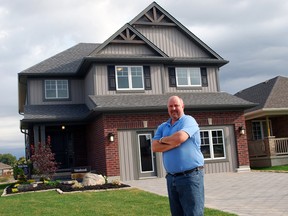 Doug Tarry Jr., director of marketing for Doug Tarry Custom Homes, stands outside a new high-performance model home in St. Thomas in this file photo. The home is part of a pilot project that aims to maximize homebuyer comfort while providing better indoor air quality and significantly reduce energy use.