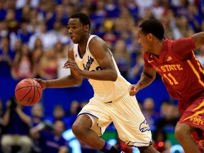 Andrew Wiggins #22 of the Kansas Jayhawks controls the ball as Monte Morris #11 of the Iowa State Cyclones defends during the game at Allen Fieldhouse on January 29, 2014 in Lawrence, Kansas. (Jamie Squire/Getty Images/AFP)