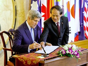 U.S. Secretary of State John Kerry signs a guestbook before meeting with ASEAN Secretary-General Le Luong Minh in Jakarta on February 16, and issued a call for the world to do to more to combat climate change. 
EVAN VUCCI/AFP