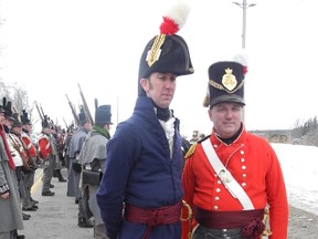 Chris McKay of London (in blue) and Tom Fournier of Cambridge (in red) prepare to reenact the Battle of Longwoods, an 1814 skirmish during the War of 1812. The re-enactment west of Delaware drew hundreds of spectators and participants on Saturday. JONATHAN SHER / THE LONDON FREE PRESS / QMI AGENCY