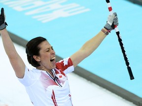 Jill Officer reacts at winning gold in the Women's Curling Flower Ceremony at the Ice Cube Curling Center during the Sochi Winter Olympics on February 20, 2014. (AFP PHOTO/JUNG YEON-JE)