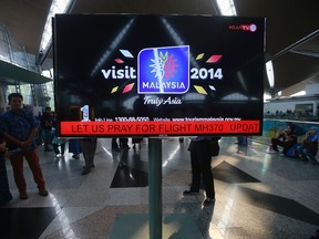 An information screen displays a message "Let Us Pray For Flight MH370", regarding the missing Malaysia Airlines flight, at Kuala Lumpur International Airport in Sepang, March 8, 2014. REUTERS/Samsul Said