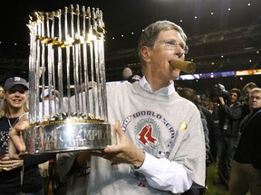 Boston Red Sox principal owner John Henry holds the World Series trophy during celebrations in Denver, Colorado, in this October 28, 2007 file photo (REUTERS/Lucy Nicholson/Files)