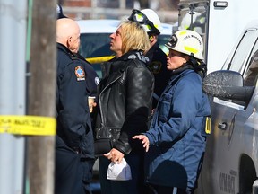The Ontario Fire Marshall speaks to witness Carson Foster at the the scene near Dupont and Dovercourt Sts. of a fire on March 7, 2014 that left three dead and another in hospital (Dave Abel/Toronto Sun)