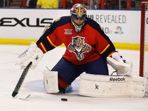 Goalkeeper Roberto Luongo follows the play during his first game back with the Florida Panthers on Wednesday against Buffalo. Inset, centre Mike Cammalleri was still a Calgary Flame following the trade deadline, much to the surprise of some. REUTERS