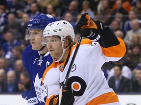 Captains Dion Phaneuf of the Leafs (left) and Claude Giroux of the Flyers jostle in the Toronto zone last night at the ACC. (JACK BOLAND/Toronto Sun)
