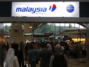 Passengers queue up at the Malaysia Airlines ticketing booth at the Kuala Lumpur International Airport in Sepang March 9, 2014. REUTERS/Edgar Su