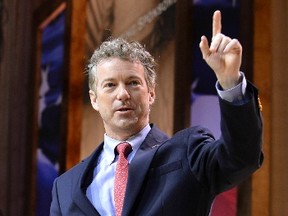 Senator Rand Paul waves as he arrives onstage, wearing blue jeans and cowboy boots, to deliver remarks at the Conservative Political Action Conference (CPAC) in Oxon Hill, Maryland, March 7, 2014. (REUTERS/Mike Theiler)