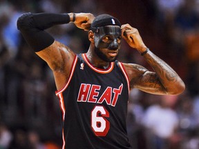 Miami Heat small forward LeBron James (6) puts on his protective mask during the first half against the New York Knicks at American Airlines Arena. (Steve Mitchell-USA TODAY Sports)
