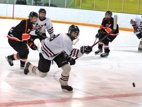 Midget Hawk Kole Ashbacher dumps the puck into Oyen's zone Saturday night at the Vulcan District Arena during first period action in the first game of semi-finals in the Central Alberta Hockey League. The Hawks won 7-0 and played again in Oyen Sunday night. They won again, this time 4-1, and go on to play in the league finals against Medicine Hat.