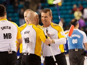 Manitoba skip Jeff Stoughton celebrates his team's bronze-medal finish with third Jon Mead after defeating Quebec at the 2014 Tim Hortons Brier Canadian men's curling championships in Kamloops, B.C. on March 9, 2014. (BEN NELMS/Reuters)