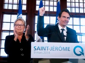 Pierre Karl Peladeau (R), former president and CEO of Quebecor Inc., gestures after being announced as the Parti Quebecois candidate for the riding of Saint-Jerome by leader Pauline Marois during a campaign stop in Saint-Jerome, Quebec, March 9,  2014. REUTERS/Christinne Muschi