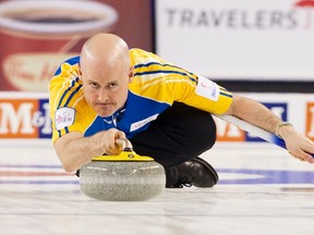 Team Alberta's skip Kevin Koe throws a rock in the first end against team British Columbia during the championship draw at the 2014 Tim Hortons Brier curling championships in Kamloops, British Columbia March 9, 2014.  (REUTERS)