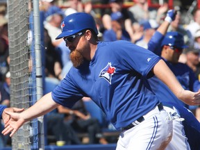 Blue Jays Adam Lind comes in for a run against the Minnesota Twins in Dunedin on Saturday. (Veronica Henri/Toronto Sun/QMI Agency)