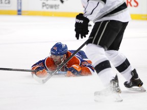 Edmonton forward Sam Gagner (89) hits the ice after a collision with L.A. defenceman Alec Martinez (27) during an NHL game between the Edmonton Oilers and the Los Angeles Kings at Rexall Place in Edmonton, Alta., on Sunday, March 9, 2014. Ian Kucerak/Edmonton Sun/QMI Agency