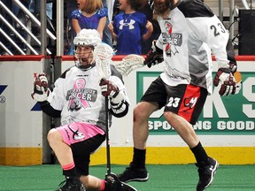 Sean Pollock, left, of Port Lambton celebrates his overtime goal with Colorado Mammoth teammate Athan Iannucci in a 10-9 win over the Calgary Roughnecks on Saturday in Denver. (BART YOUNG/Colorado Mammoth)