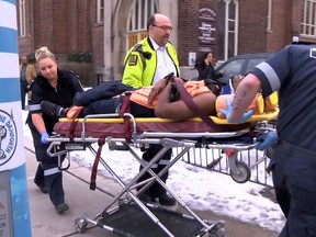 Paramedics rush a man to St. Michael's Hospital after he was stabbed during a church service Sunday, March 9, 2014. (JOHN HANLEY/Special to the Toronto Sun)
