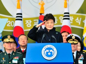South Korean President Park Geun-hye salutes during a joint commissioning ceremony for 5,860 new officers from the Army, Navy, Air Force and Marines at the military headquarters in Gyeryong, south of Seoul on March 6, 2014. (REUTERS/Jung Yeon-je/Pool)