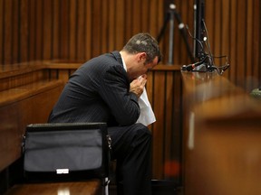 Olympic and Paralympic track star Oscar Pistorius blows his nose in the dock during his trial for the murder of his girlfriend Reeva Steenkamp, at the North Gauteng High Court in Pretoria, March 10, 2014. (REUTERS)