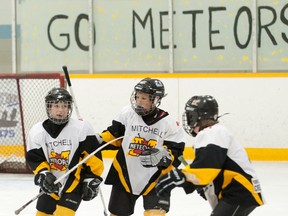 Joey Hill (middle) and Carter Preszcator (right) of the Mitchell Atom rep hockey team congratulate Connor Lockhart on his second goal of the game as the Meteors edged Twin Centre 3-2 to win their best-of-five OMHA ‘CC’ semi-final series in five games Saturday, March 8 at the Mitchell & District Arena. The win pits the locals against Wasaga Beach in the provincial final, while earlier in the day the Atom AE squad disposed of Douro in five games with a narrow 1-0 victory to also earn a berth in the OMHA AE Group 4/5 final. The Mitchell Pee Wees are also in the OMHA finals, taking on Schomberg. JEFF LOCKHART PHOTO