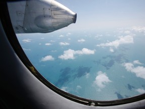 Clouds hover outside the window of a Vietnam Air Force search and rescue aircraft An-26 on a mission to find the missing Malaysia Airlines flight MH370, off Vietnam's Tho Chu island March 10, 2014. (Reuters)